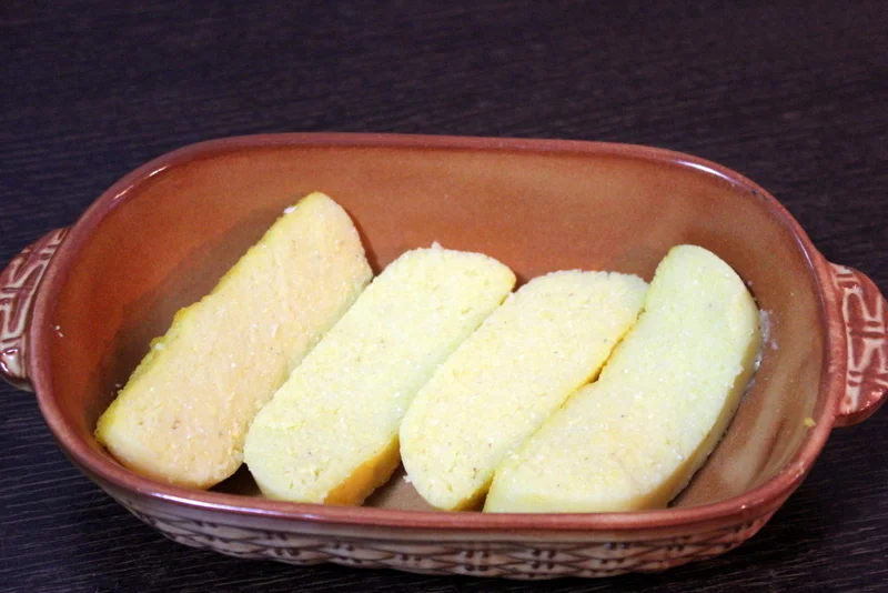 Mushrooms with cheese and eggs on a bed of polenta