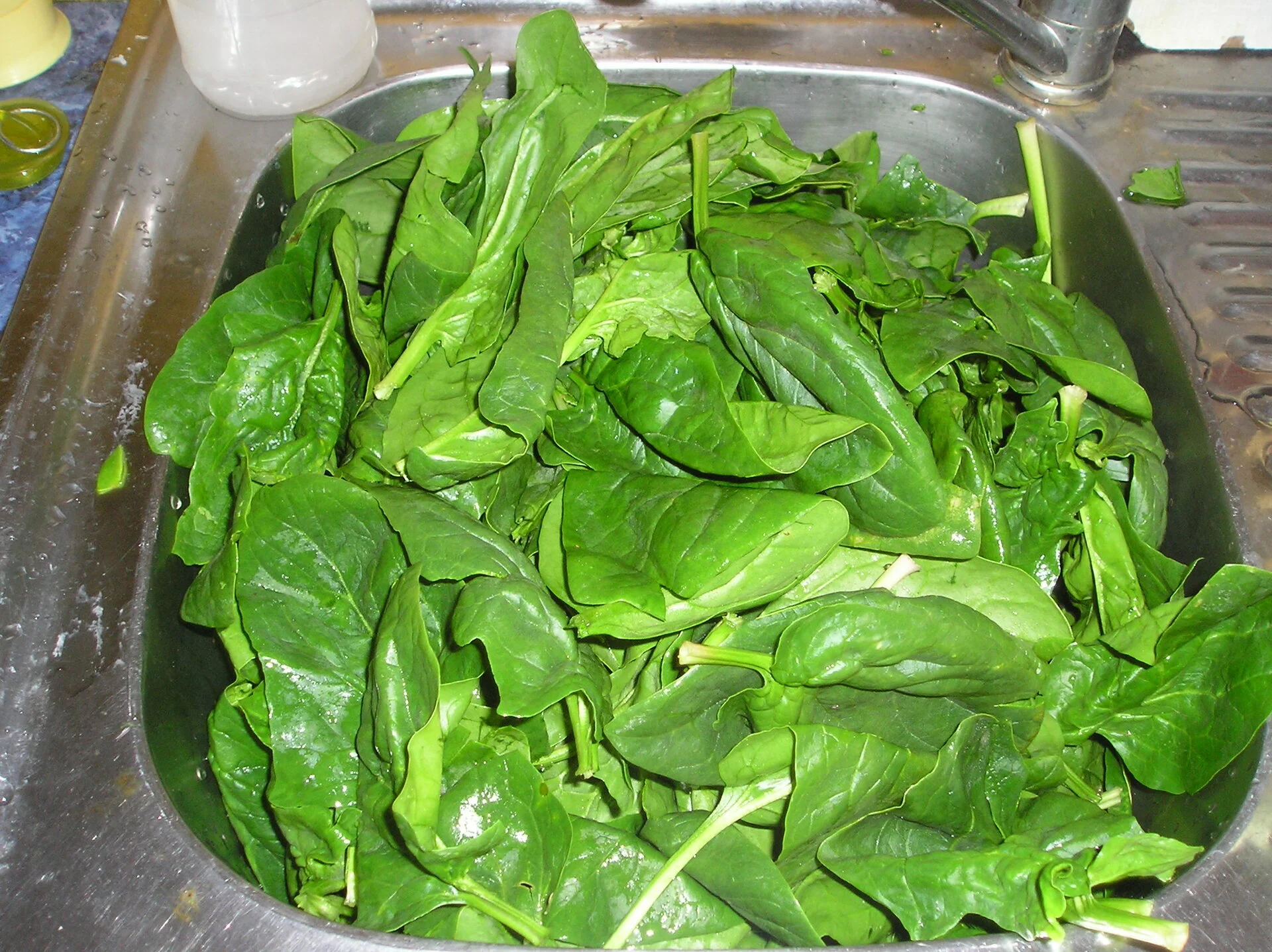 Spinach with fried eggs in clay shape
