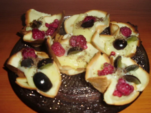 Autumn baskets with grapes and raspberries