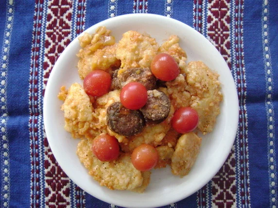 Dumplings with vegetable sauce and sausages