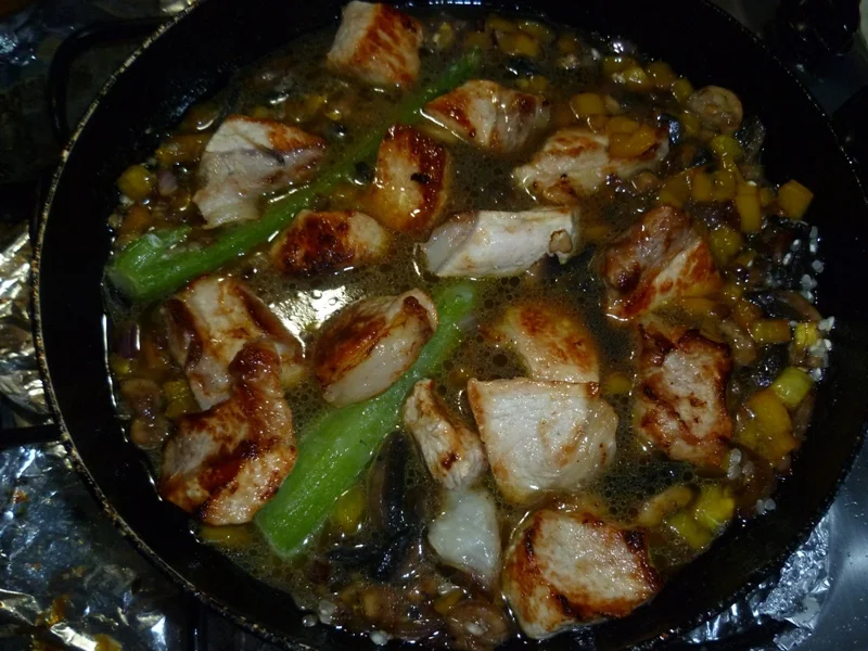 Oven-baked pork with rice and olives