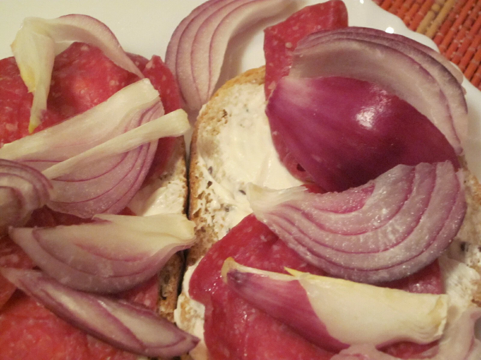 Sandwich with fine something, raw ham and red onion