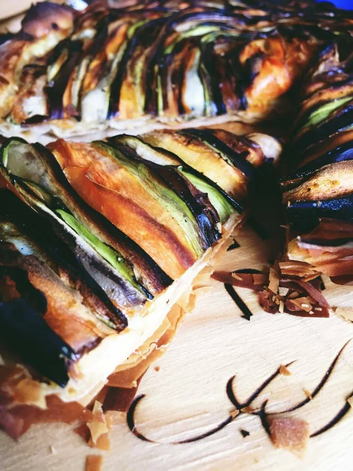 Multicolored vegetable tart with crème fraîche and sage