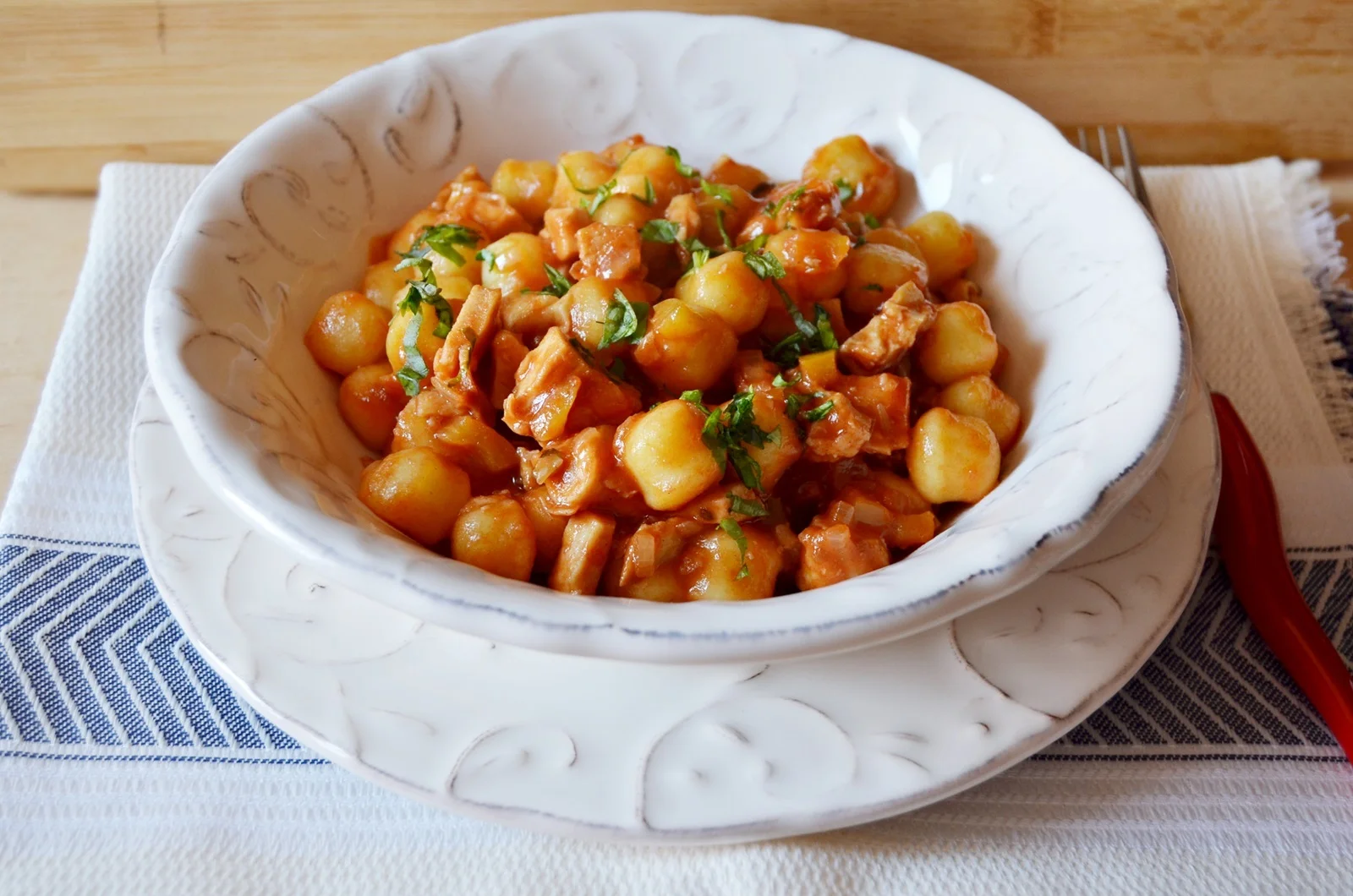 Potato dumplings with tomato sauce and chicken breast