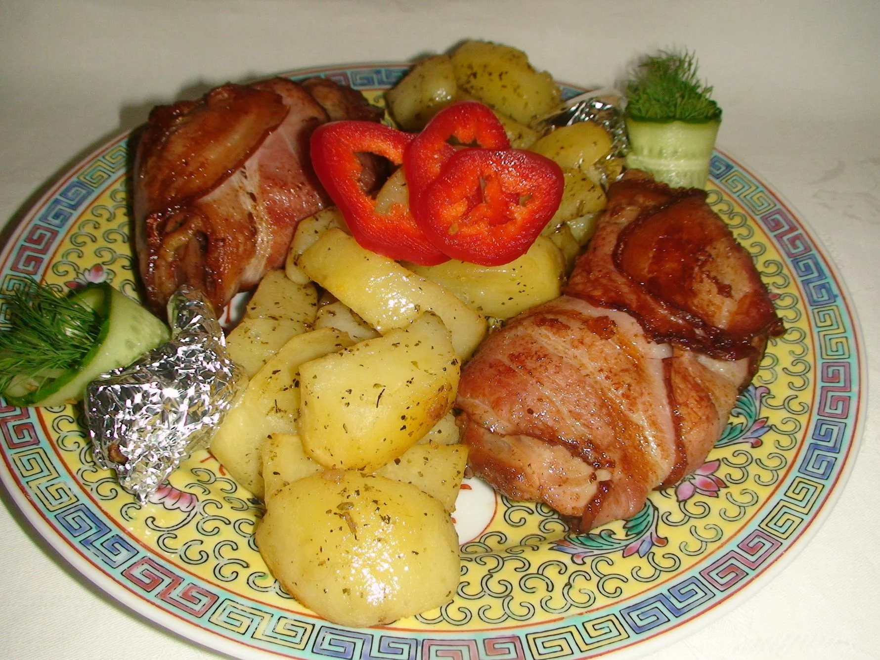 Bacon-wrapped chicken thighs with baked potatoes