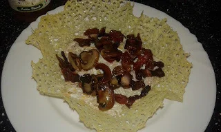 Pasta with bacon and mushrooms in a cheese basket