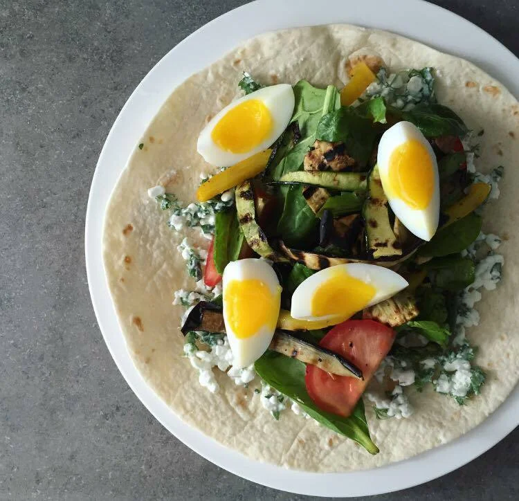 Tortilla filled with spinach, boiled eggs, and cottage cheese