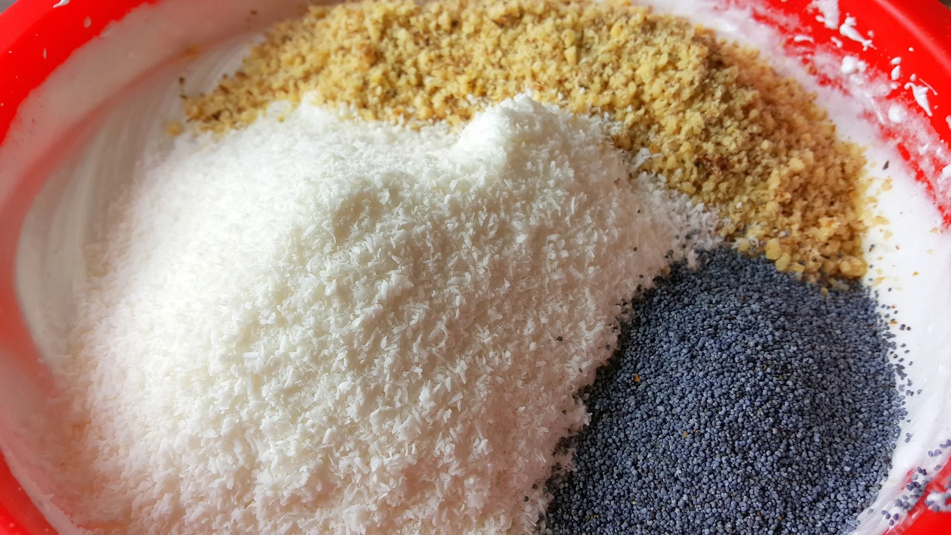 Egg white cake with cherries, walnuts, coconut, and poppy seeds