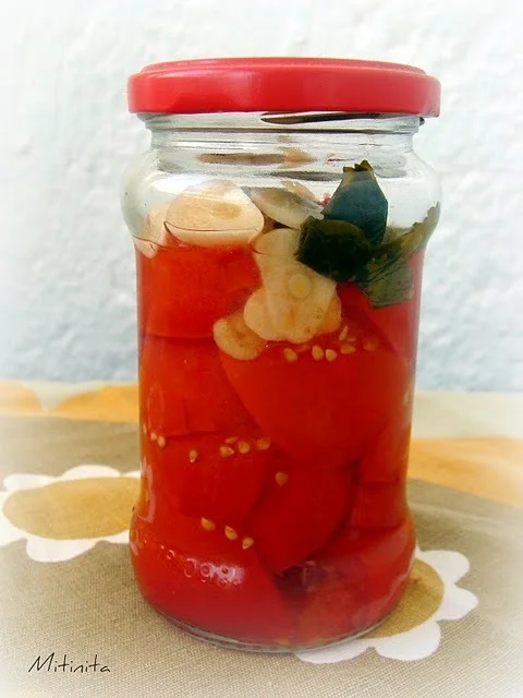 Tomatoes in a jar with garlic and basil