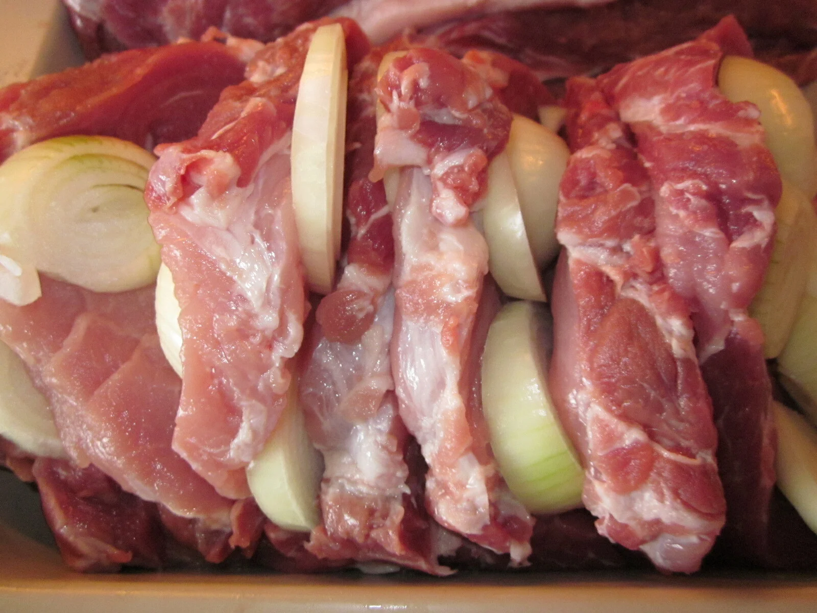 Pork neck with onion, ham, and apples