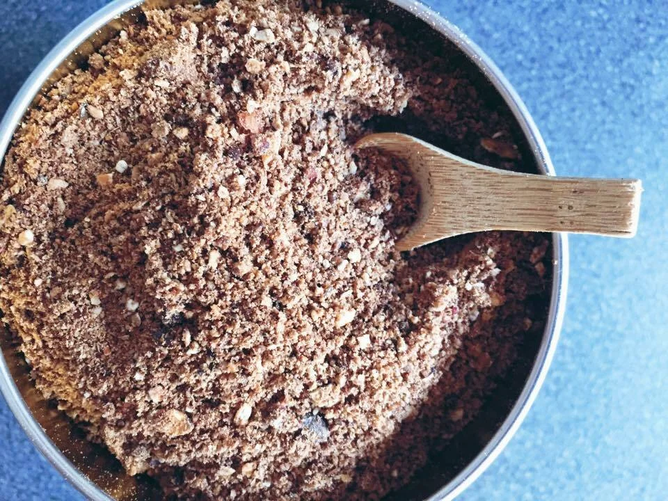 Granola powder with seeds, nuts, oats, and fruits