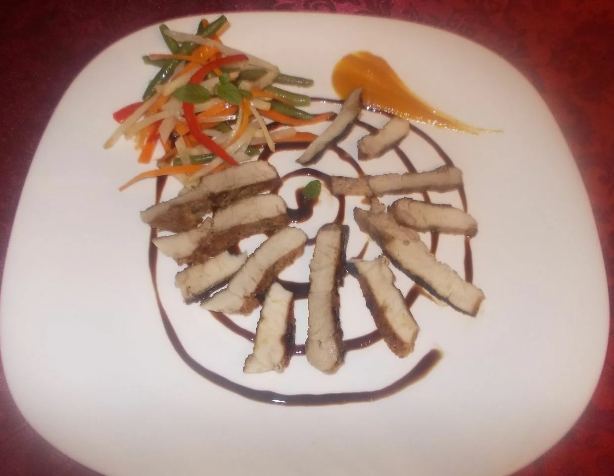 Pork neck with vegetable tagliatelle and pumpkin sauce