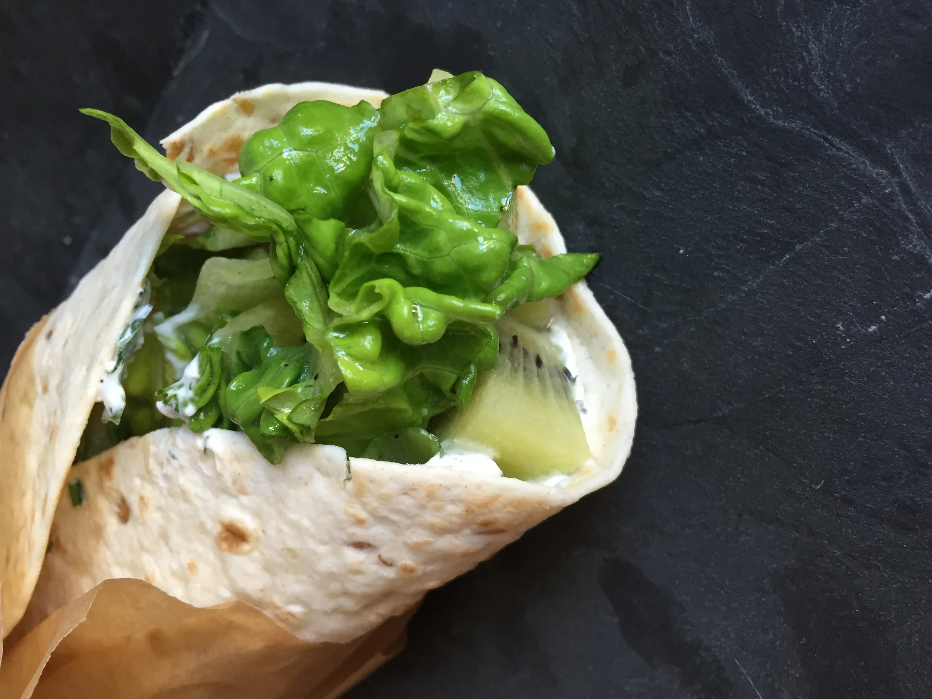 Tortilla filled with herb cream cheese and Kiwi