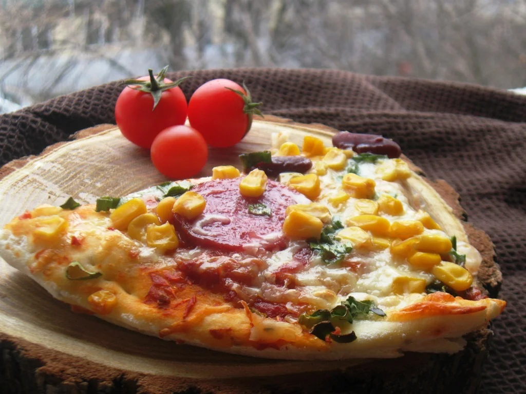 Pizza with dry salami and corn