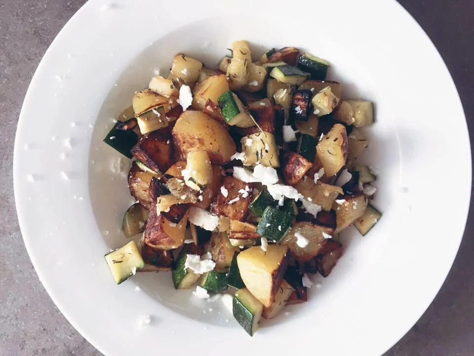 Fried potatoes with zucchini and feta cheese