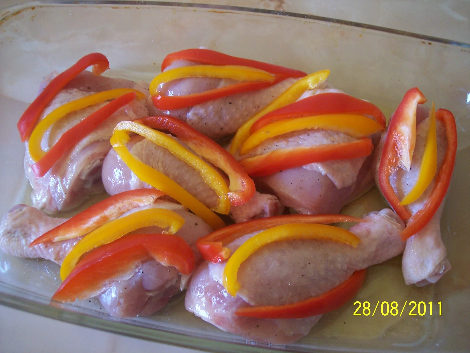 Chicken thighs with bell peppers and wine baked in the oven