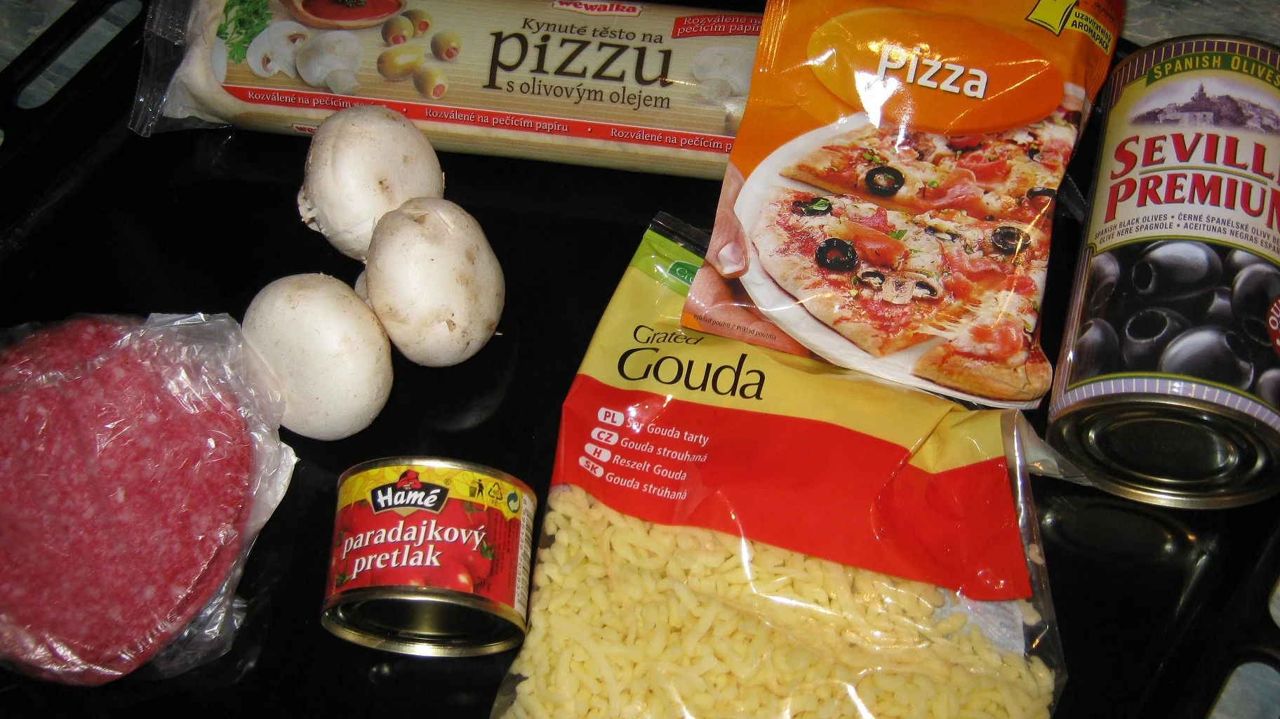 Pizza with salami and mushrooms