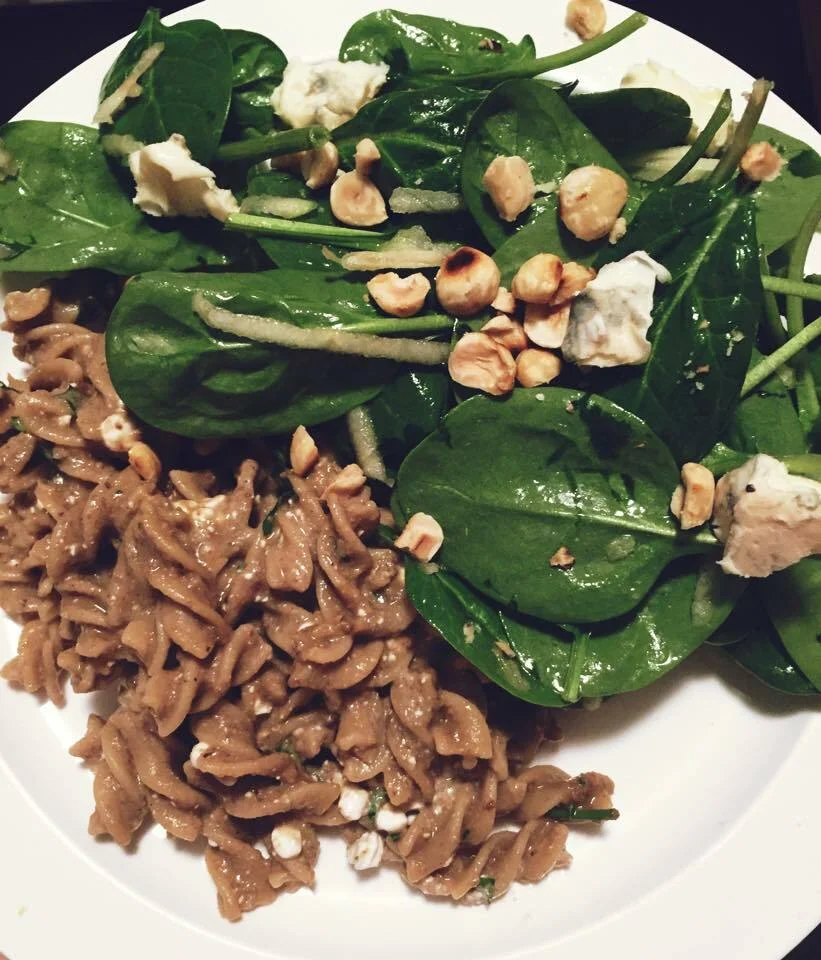 Fusilli in mushroom sauce and spinach salad with apple, blue cheese, and hazelnuts