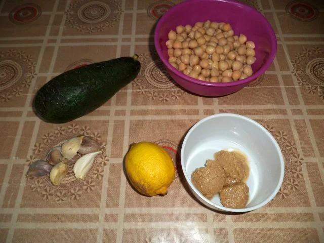 Hummus-filled tarts with avocado, pumpkin seeds, and chia.